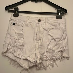 White jean shorts with holes, lightly worn